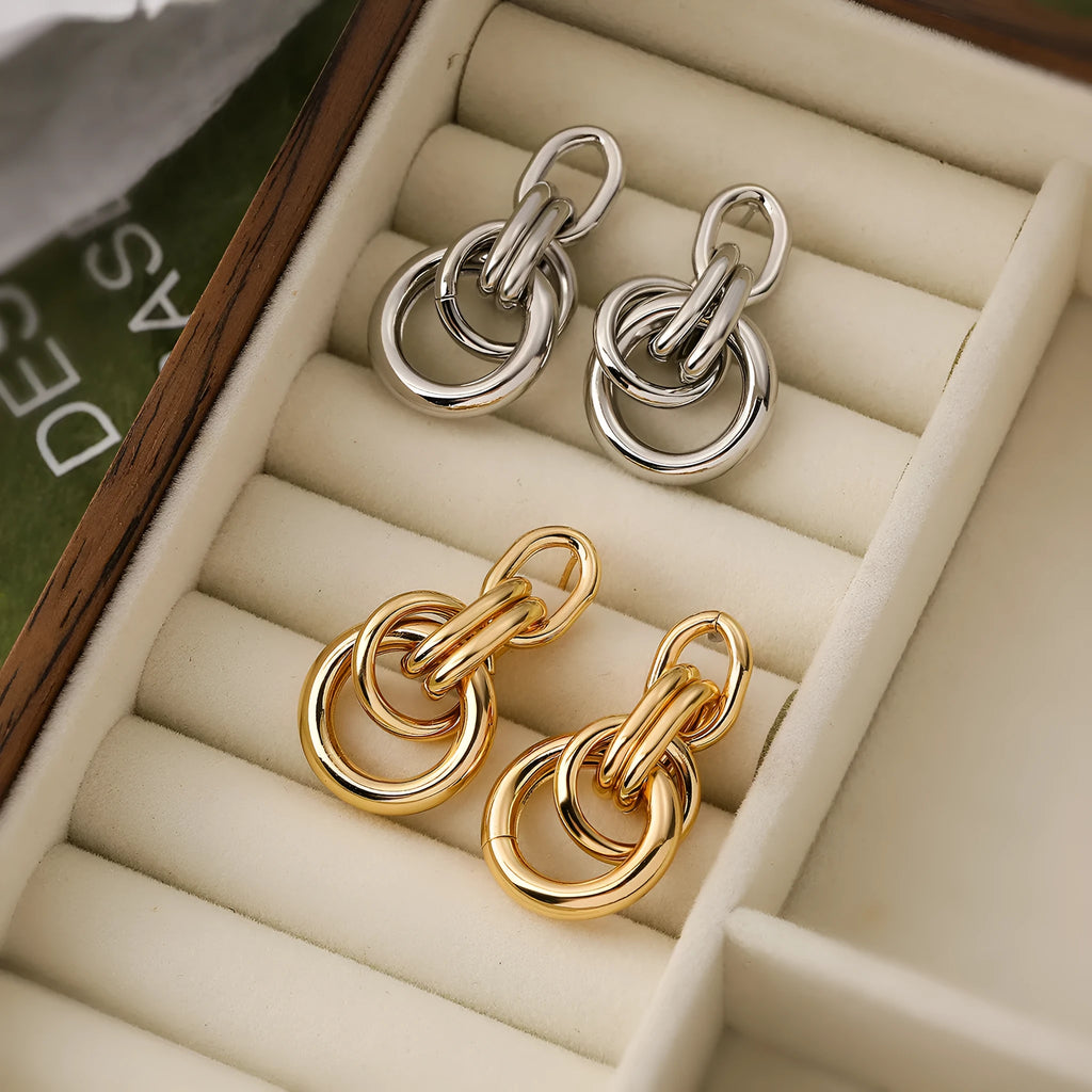 A pair of gold geometric earrings for women with an irregular shape, made from copper.