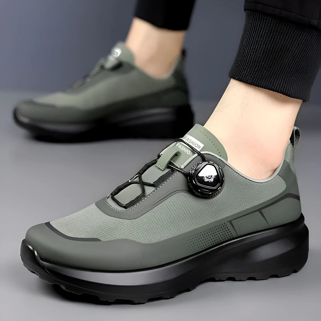 Men's black casual sneakers with a rotating button closure and thick platform sole.