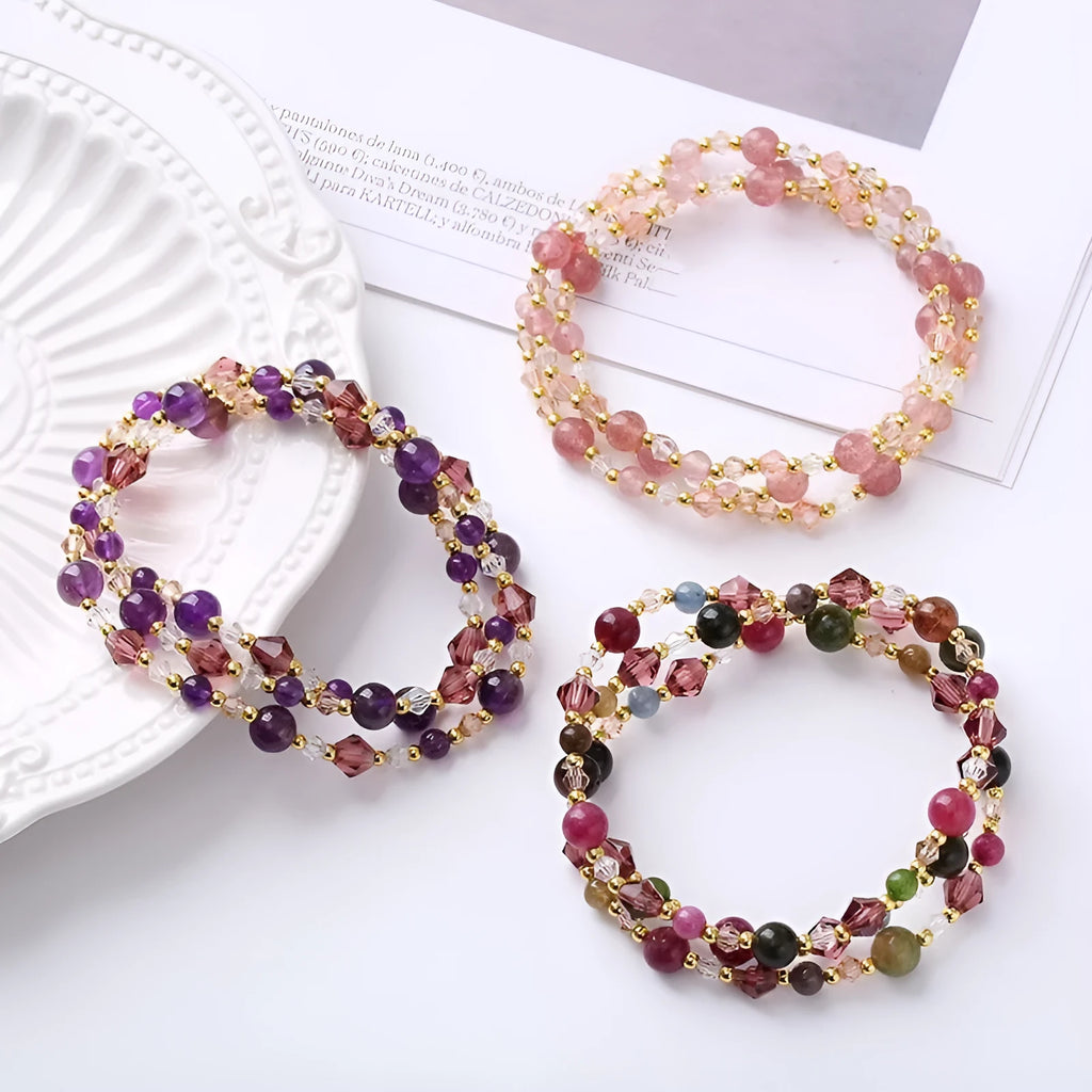 Colourful handmade crystal bracelet with tourmaline, strawberry quartz, and amethyst beads on an adjustable cord.