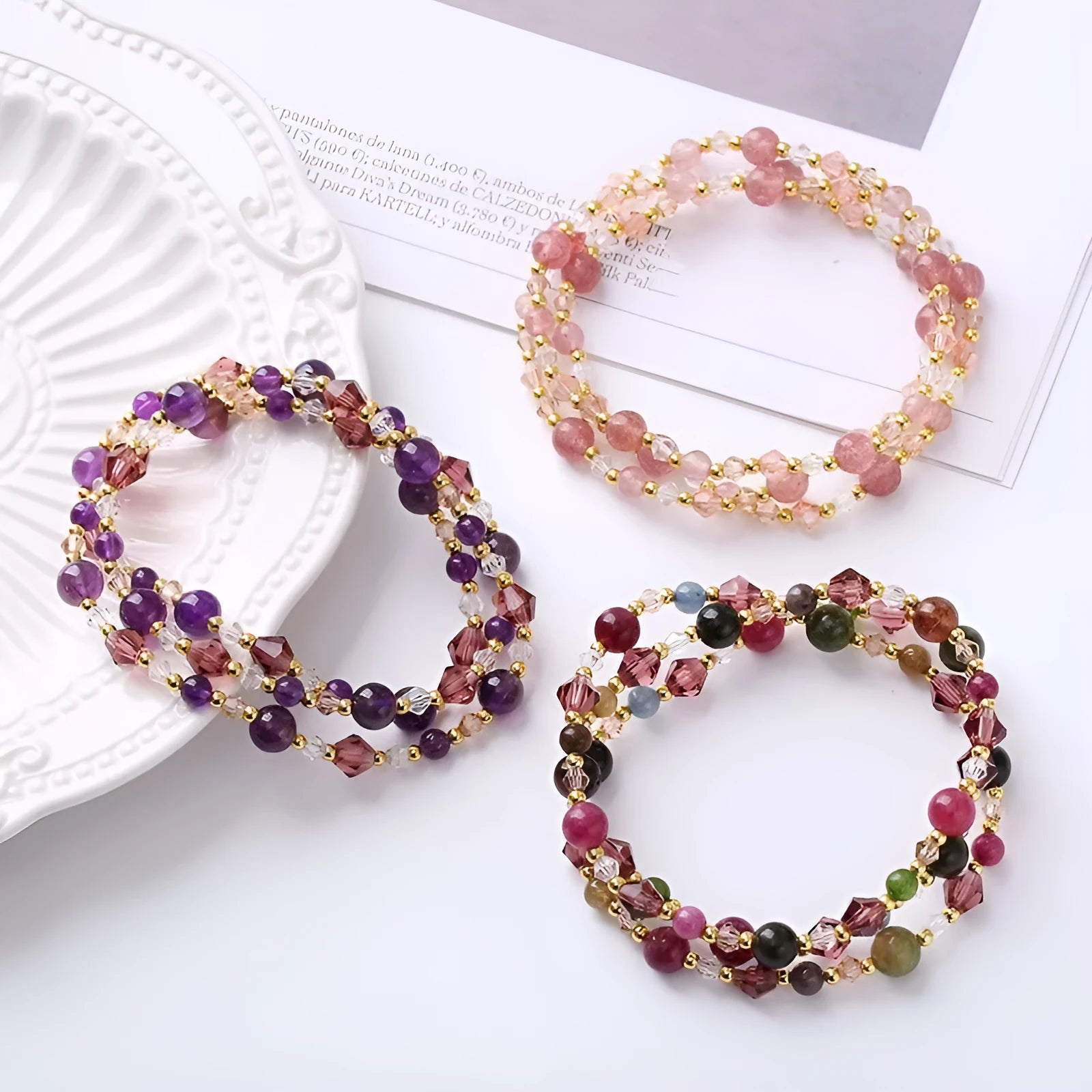Colourful handmade crystal bracelet with tourmaline, strawberry quartz, and amethyst beads on an adjustable cord.