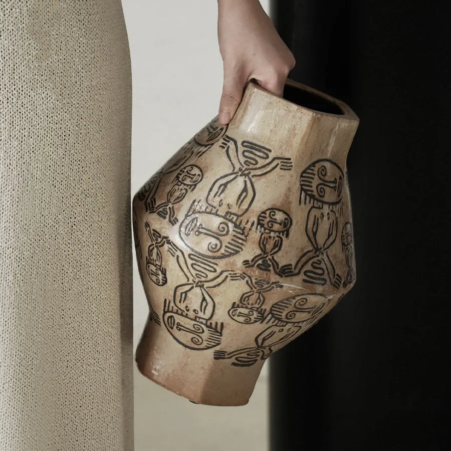 Hand-painted ceramic vase with vintage carved religious patterns in cylindrical shape