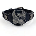 Black geometric eagle head leather bracelet with tapered width and button fastening.
