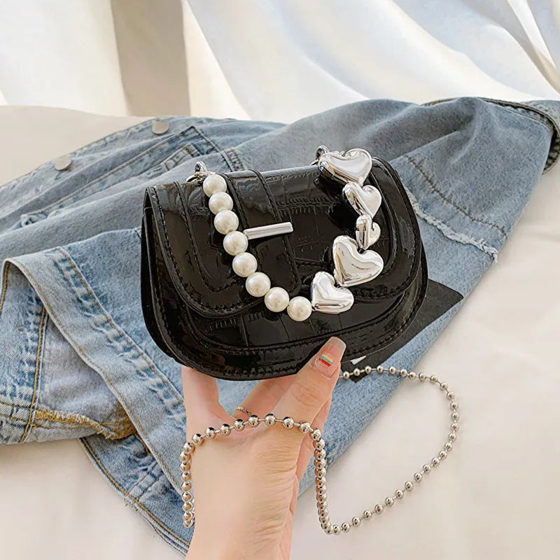 Silver laser pearl women's mini crossbody bag with a horizontal square shape and single shoulder strap.