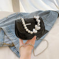 Silver laser pearl women's mini crossbody bag with a horizontal square shape and single shoulder strap.