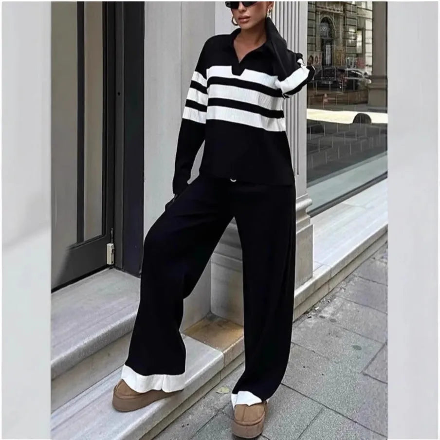 Women's black knitted two-piece set with polo collar top and straight-leg trousers.
