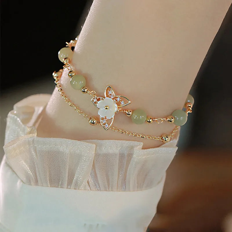 Women's yellow gold butterfly bracelet made from electroplated copper with a geometric shape.