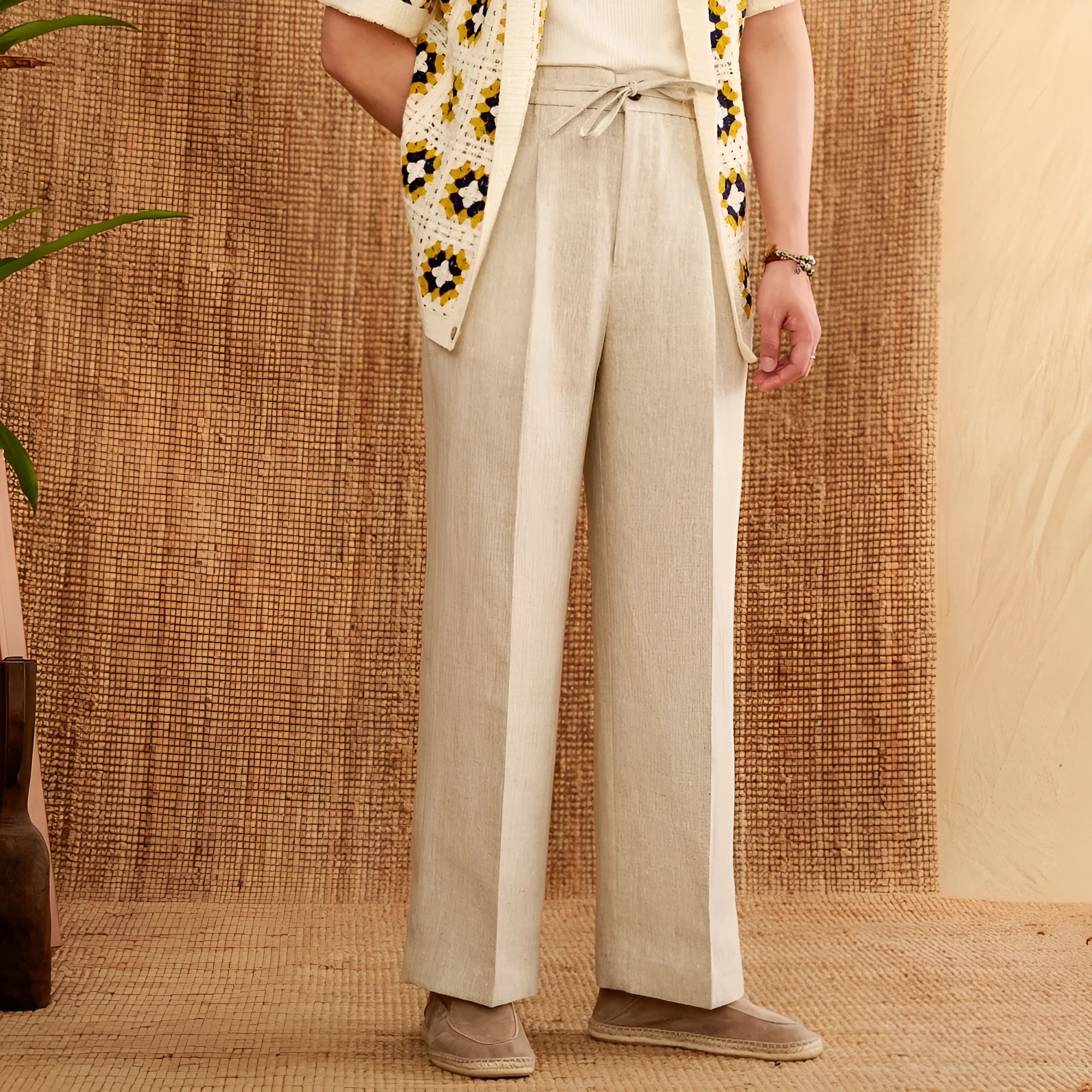 Navy blue linen high-waisted trousers with an elasticated waistband and straight-leg fit on a model.