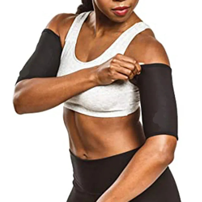 Blue compression arm band with a separate black wrist support strap laid flat.