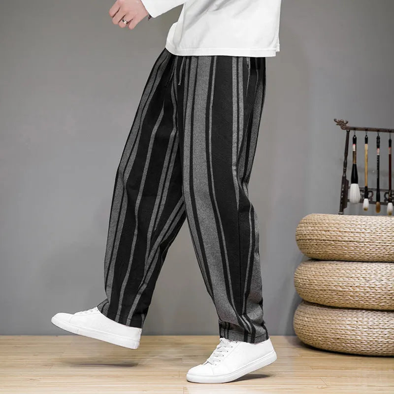 Men's navy blue and black striped wide-leg casual trousers with mid waist, laid flat.