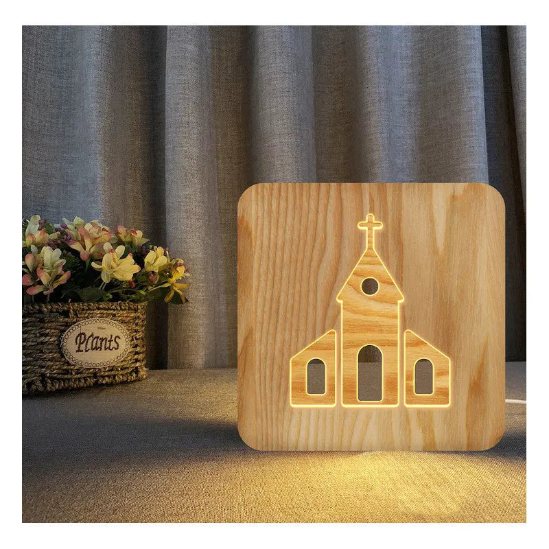 Solid wood hollow night lamp with warm white LED light on a surface.