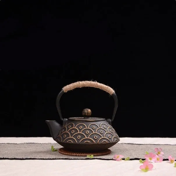 Japanese cast iron teapot in black with Peony pattern, showing lid, handle, and spout.