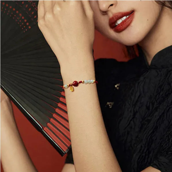 Hetian jade and cinnabar red rope women's bracelet with adjustable sterling silver chain.