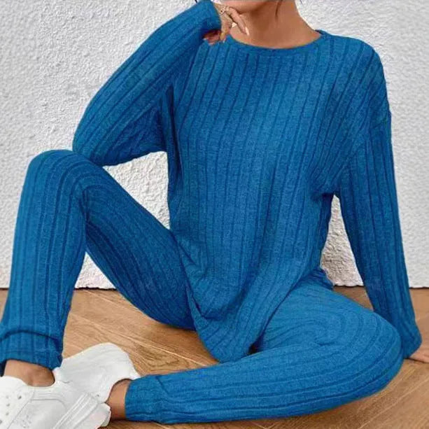 Black sunken stripe two-piece casual homewear set with top and pants on a hanger.