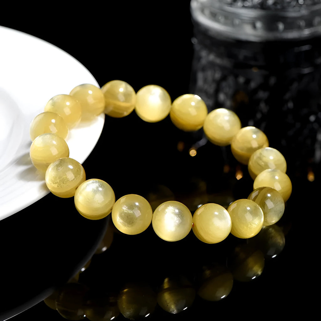 Yellow dragon gold lepidolite mica bead bracelet with geometric round beads on wrist