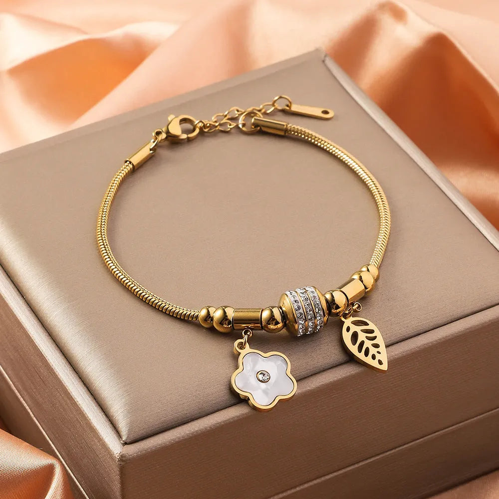 Titanium steel bracelet with electroplated colour and an inlaid shell design, showing pattern options like a five-pointed star.