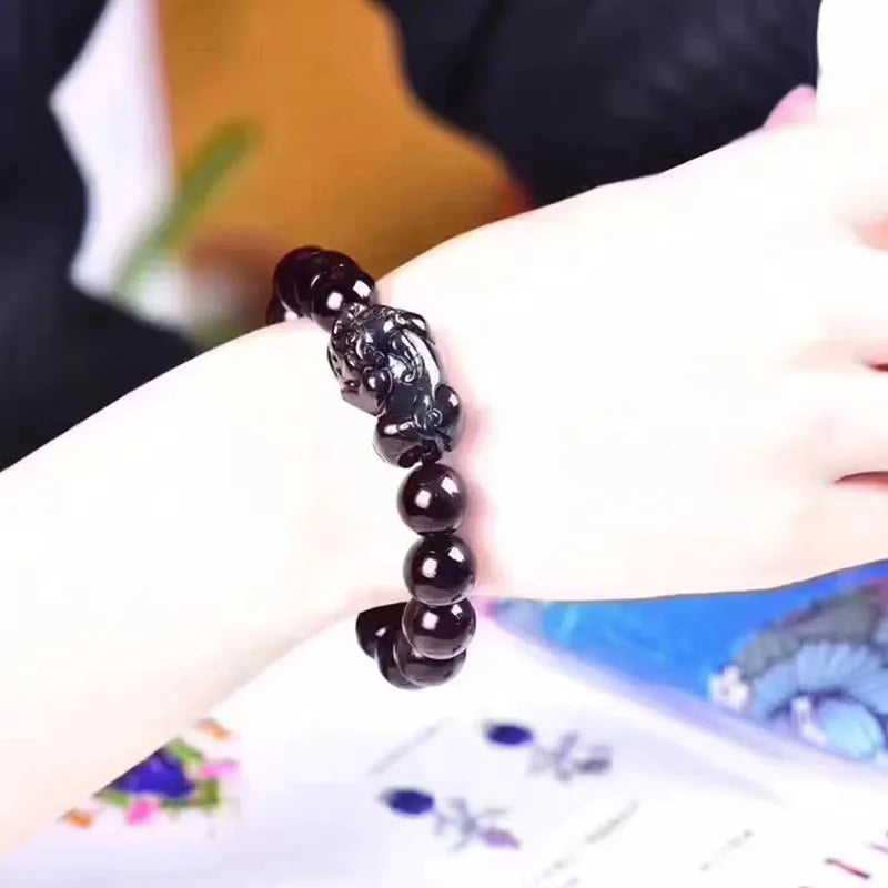 Natural ice colour polished obsidian crystal bracelet with adjustable closure on a wrist.