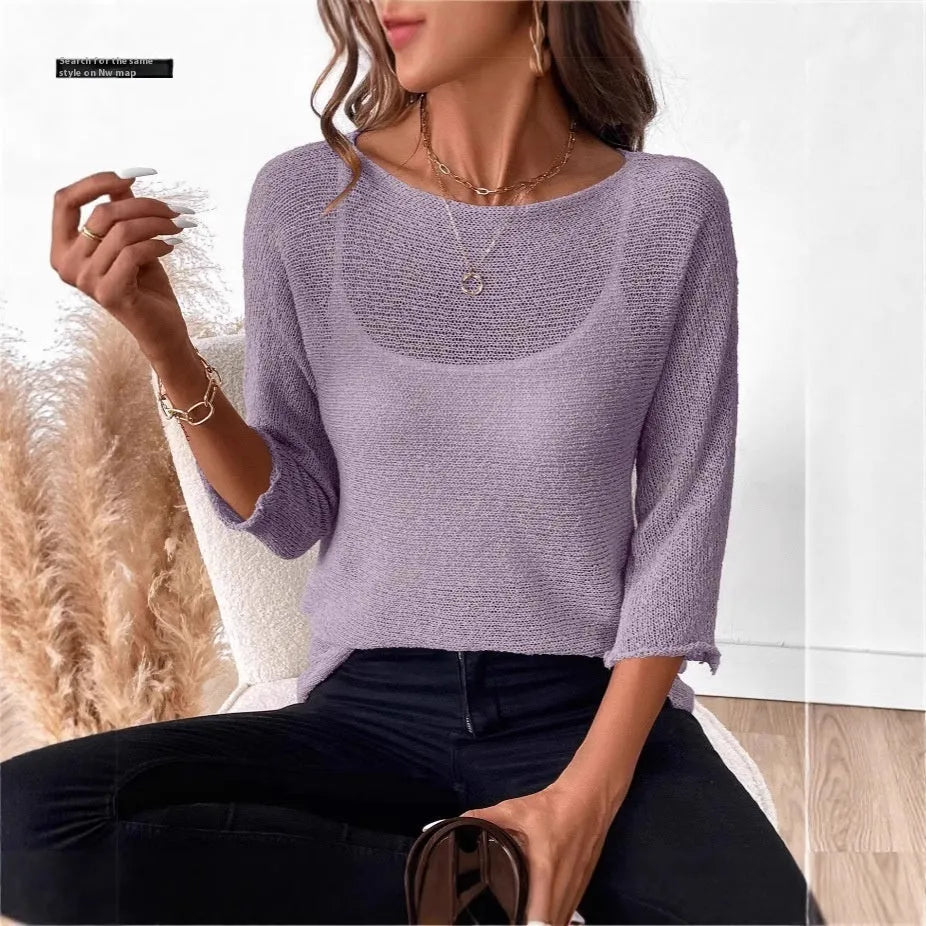 Women's light grey knitted off-shoulder top with a 3D textured pattern on a hanger.