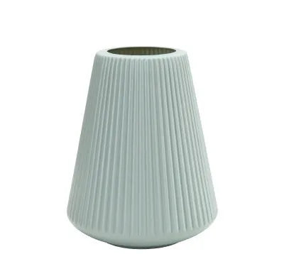 Blue melamine plastic decorative flower vase on a wooden desktop.