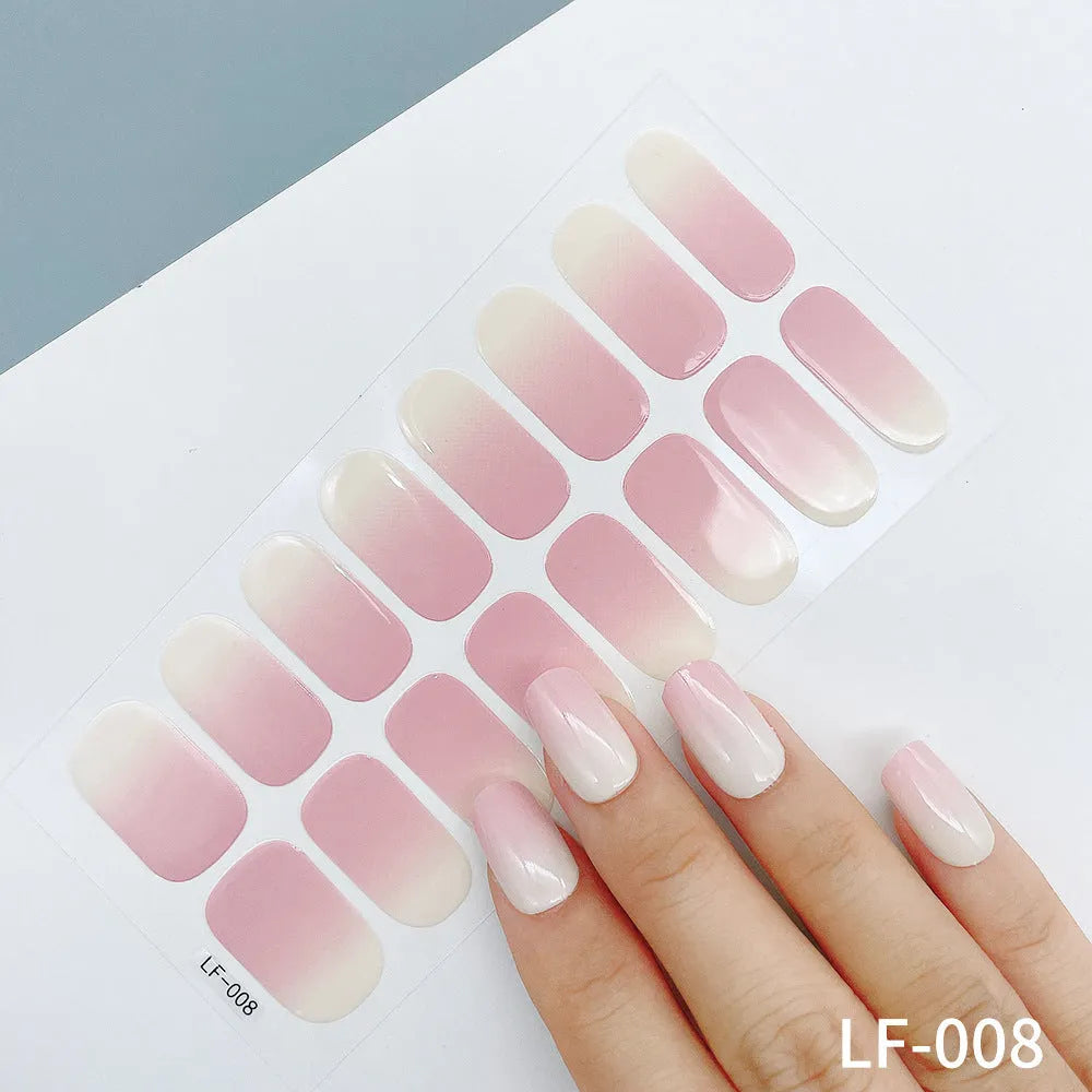 Full sheet of nail art stickers showing sixteen small designs including cross, rose, tulip, and leopard print patterns.