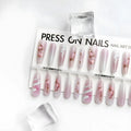 Ancient Chinese style snake year red prefabricated nail tips in drunk flower colour, long ladder shape, on a display stand