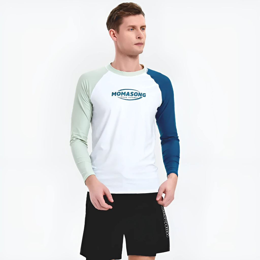 Men's white long-sleeved swim top with matching blue double-layer swim trunks on a beach.