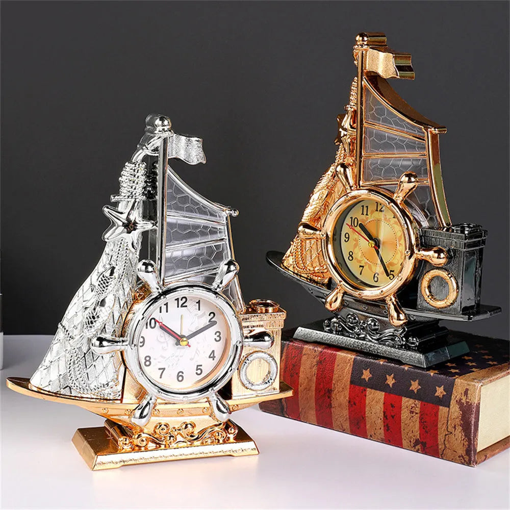 Modern metallic-finish bedroom alarm clock in gold or silver on a bedside table.