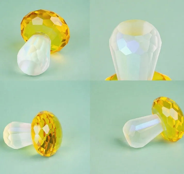 A set of colourful crystal mushroom decorations in transparent, green, red, and yellow on a white surface.