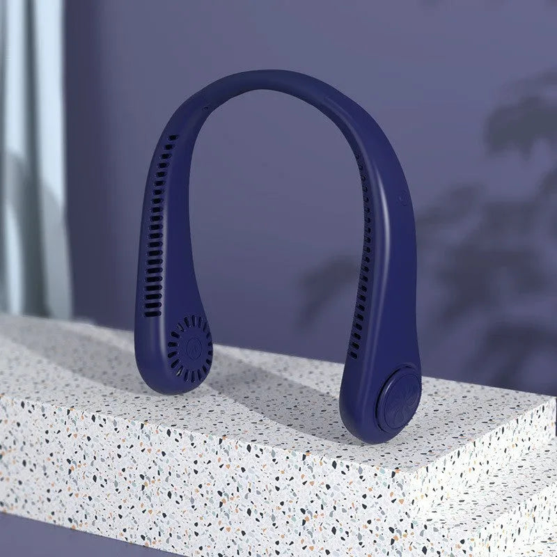 Pink portable bladeless neck fan hanging around a person's neck, showing the flexible design and air outlets.