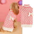 Red acrylic dog sweater with a large white love heart design on the back.