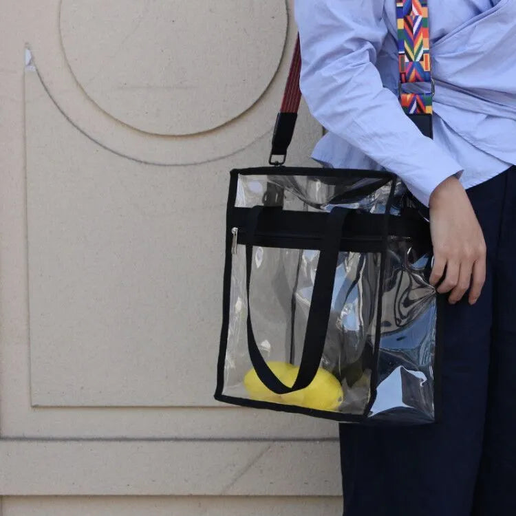 Women's transparent PVC messenger bag showing three-dimensional pocket and crossbody shoulder straps