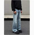Men's blue straight leg jeans with whisker washing and flared leg style on medium-high waist