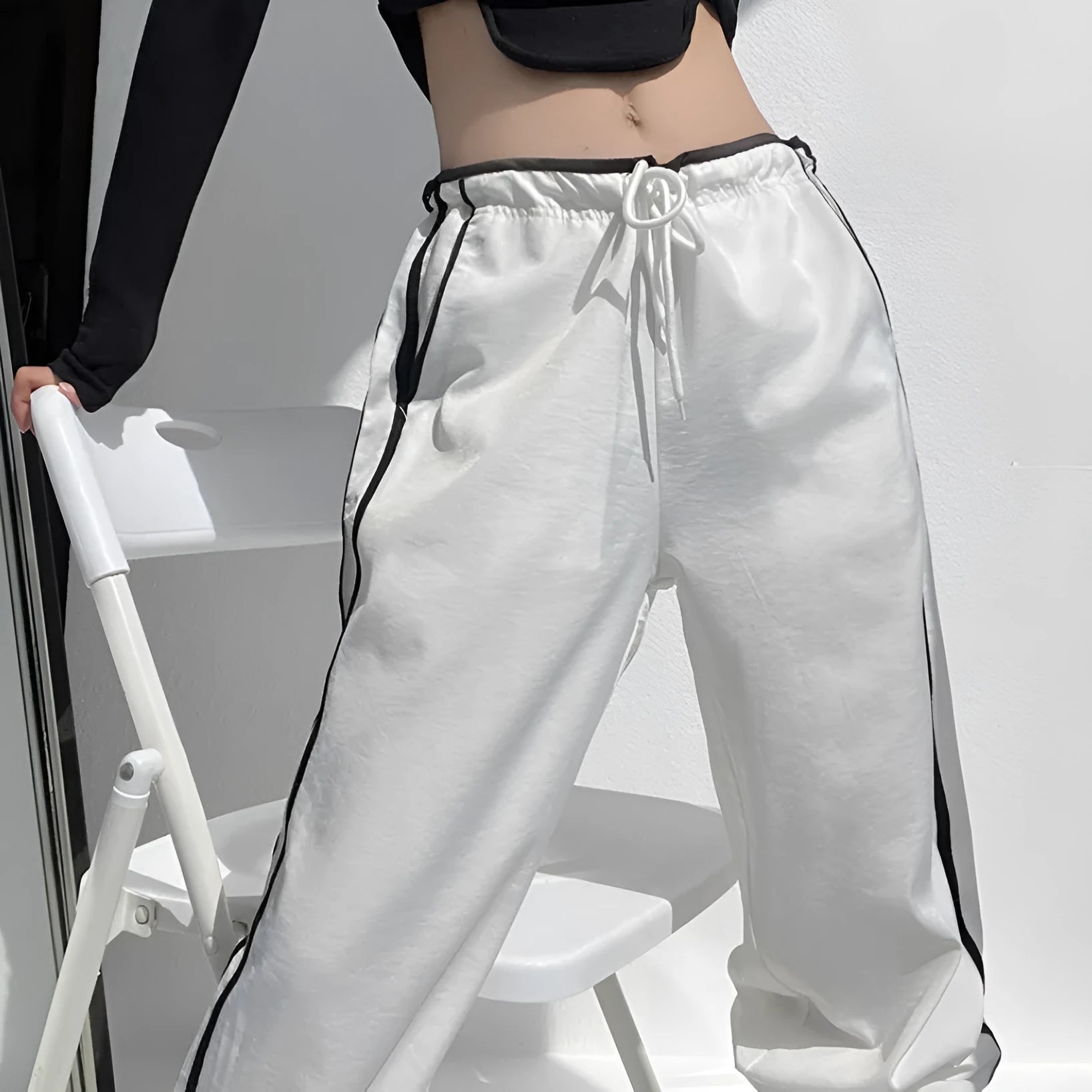 Women's navy blue straight leg trousers with a low waist and slimming drape.