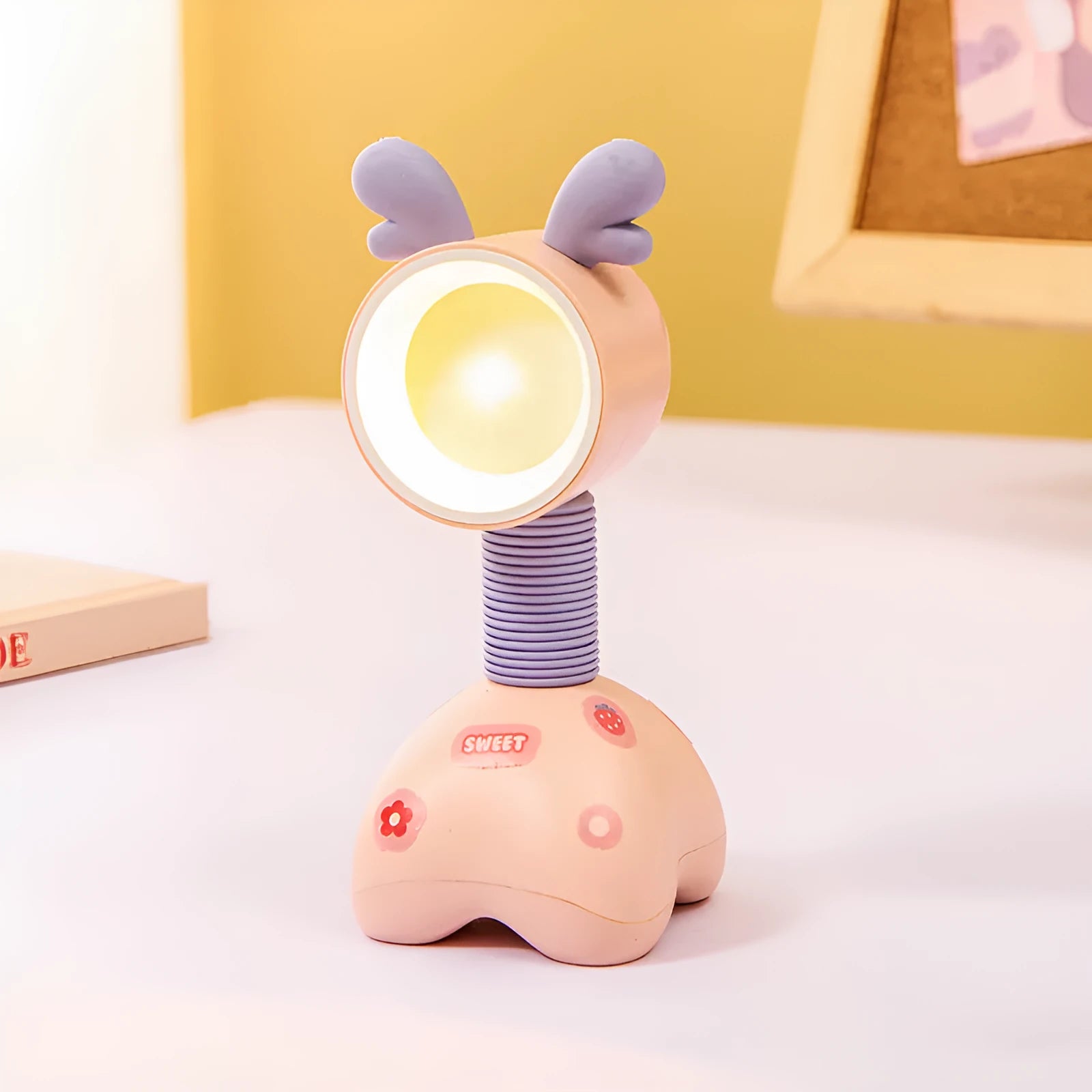 DIY cartoon animal small night lamp with magnetic base in assorted colours on a desk.