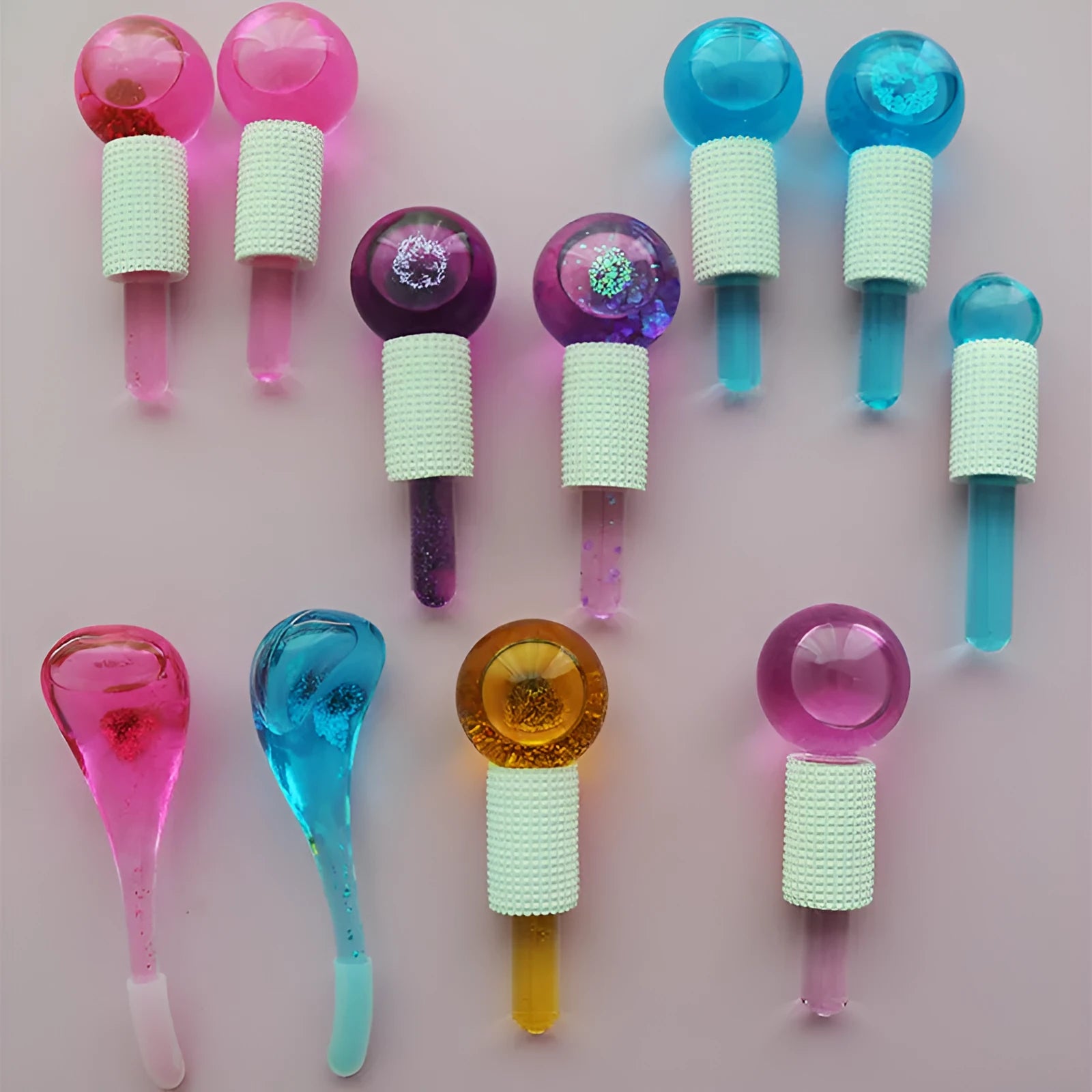Set of two beauty ice wave ball face massage tools in purple flash finish on white background