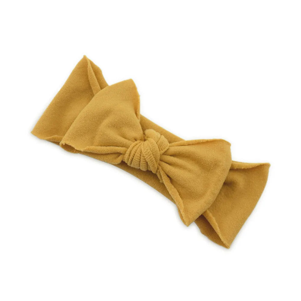 Solid colour knotted cloth headband for baby girls with bowknot design, available in 37 colours