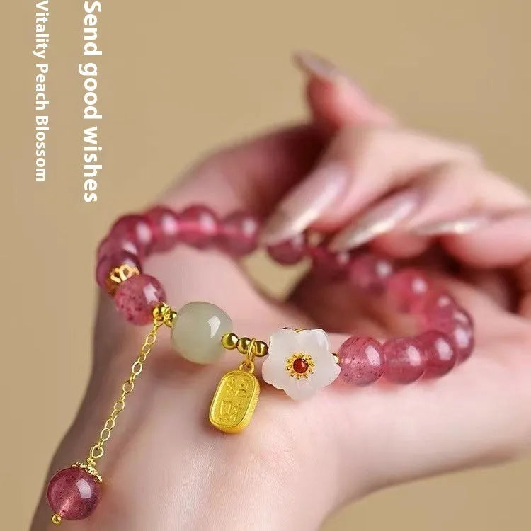 Hetian jade and strawberry quartz crystal bracelet for women showing manual craftsmanship and natural stone variations