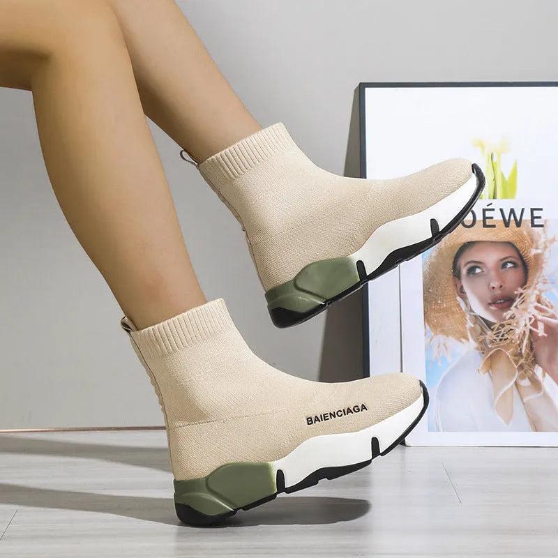 Women's black platform sock boots with cloth upper, rubber sole, round toe, thick heel, and low tube design on a neutral background