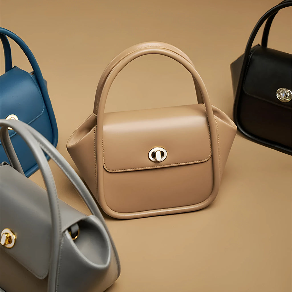 Women's leather wing tote bag with cross-body strap and latch closure in various colour options