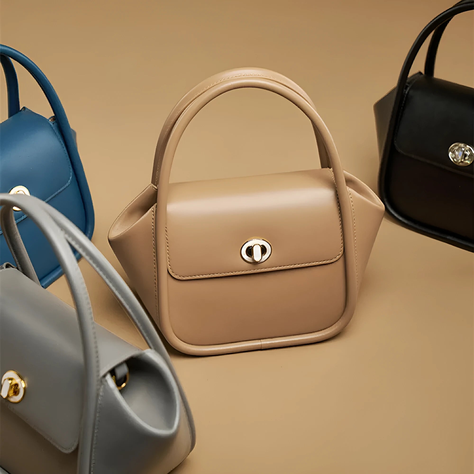 Women's leather wing tote bag with cross-body strap and latch closure in various colour options