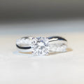 Geometric twist silver ring with 1 karat moissanite stone in four-claw winding setting