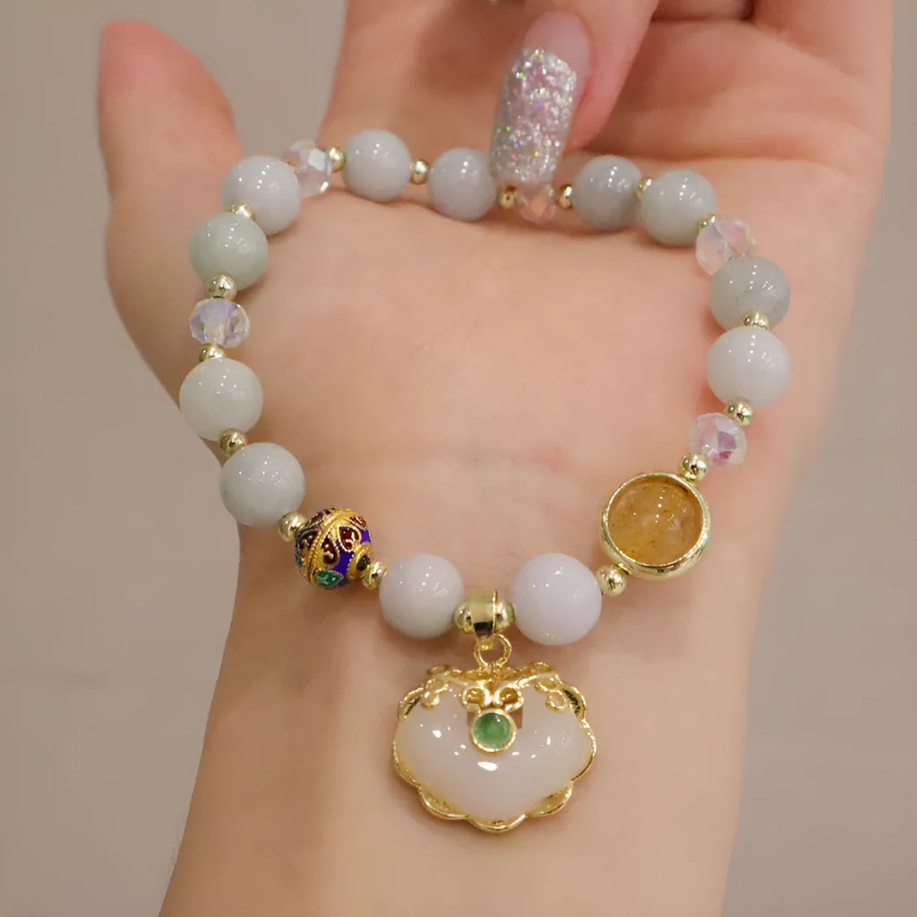 Geometric ethnic bracelet for women in choice of gray jade or strawberry quartz stone with metal decoration.