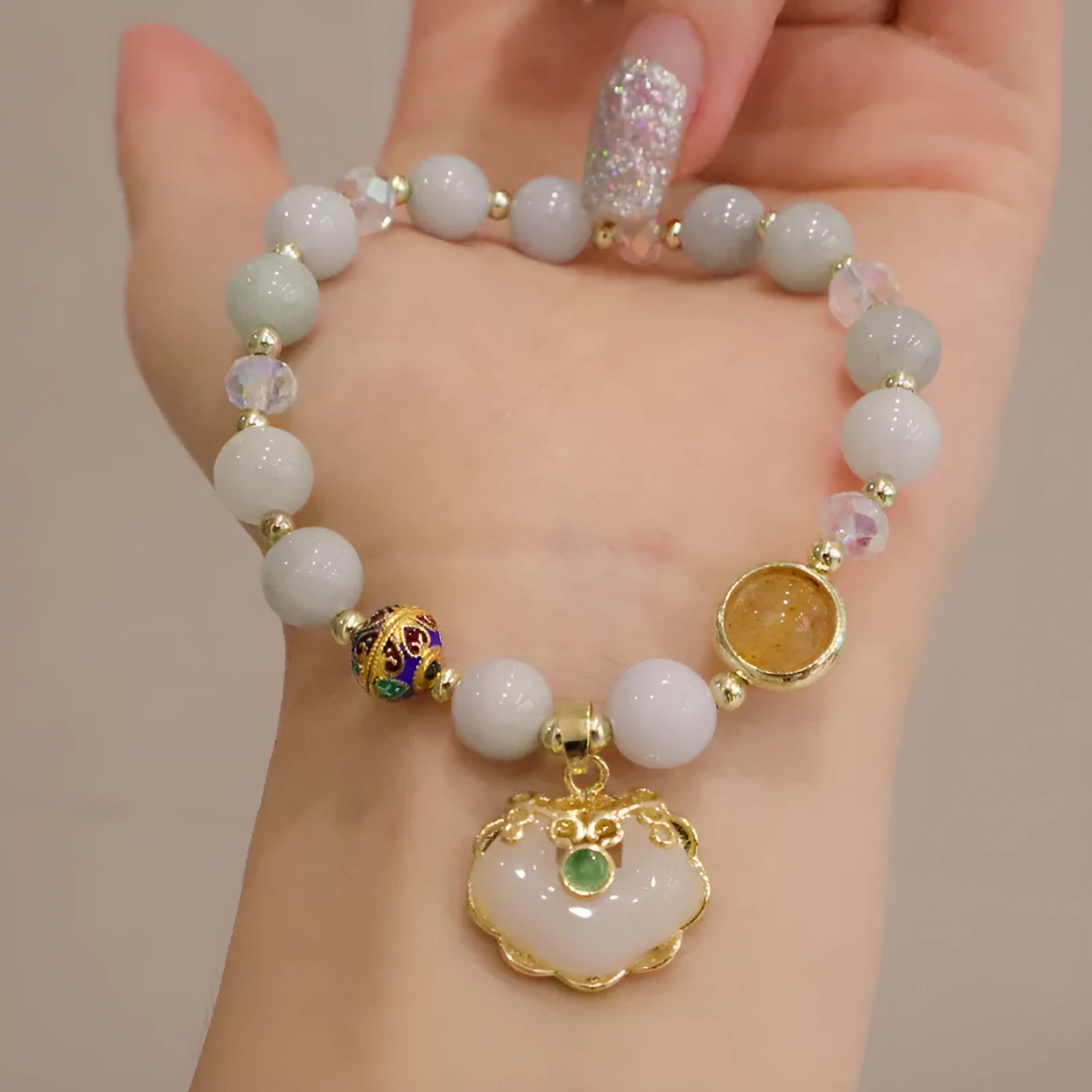 Geometric ethnic bracelet for women in choice of gray jade or strawberry quartz stone with metal decoration.