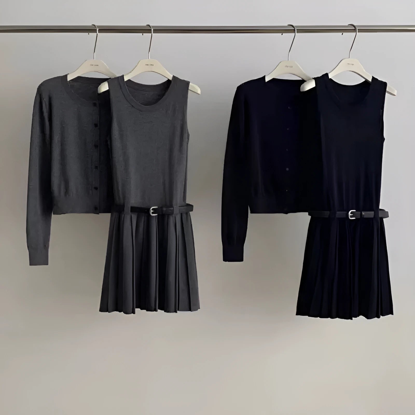 Grey art retro women's knitted cardigan and pleated vest skirt set with a waist belt.