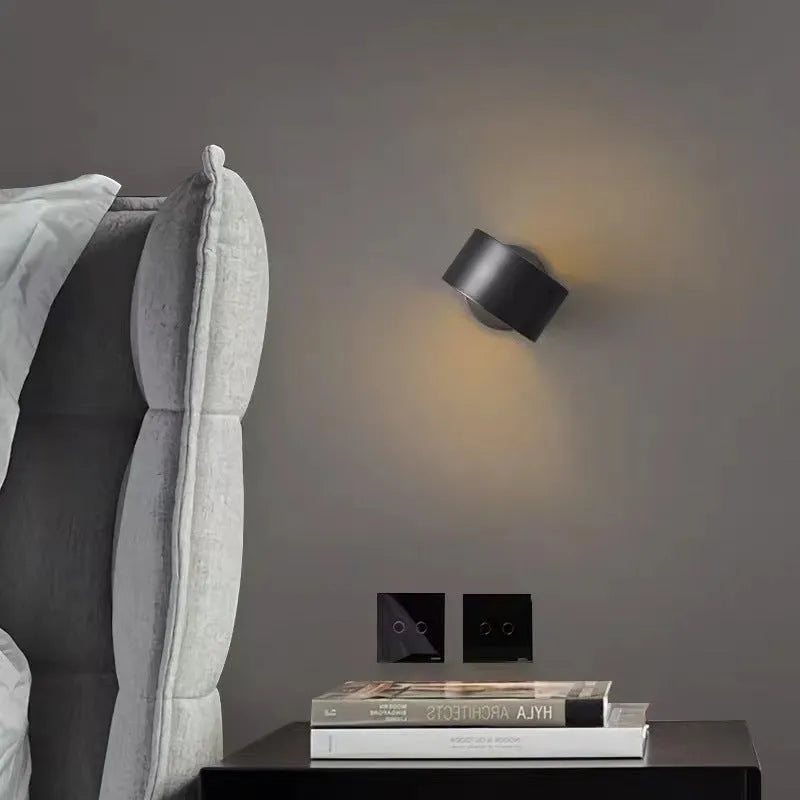 Modern copper wall light fixture in gold finish mounted on a wall