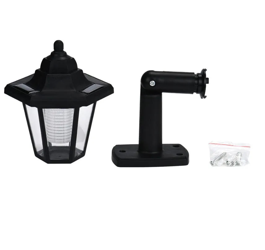 Black hexagonal solar-powered outdoor wall light with a visible solar panel and LED.