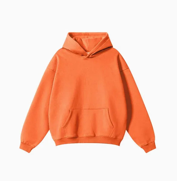 Man wearing a grey heavyweight cotton terry hooded sweater with a loose fit and drop-shoulder sleeves.