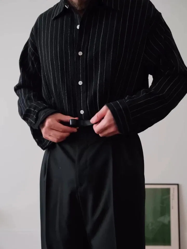 Black and white pinstriped men's long sleeve button-down shirt on a hanger.