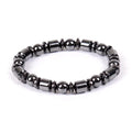 Black pentagram design magnetic therapy bracelet made from magnetite and hematite stones on a wrist.