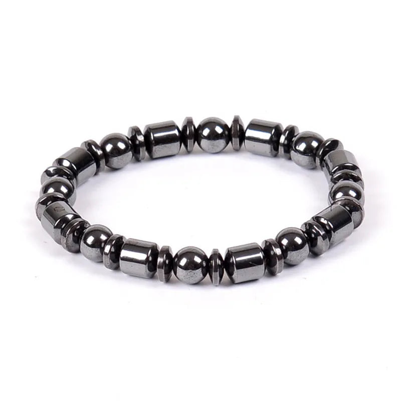 Black pentagram design magnetic therapy bracelet made from magnetite and hematite stones on a wrist.