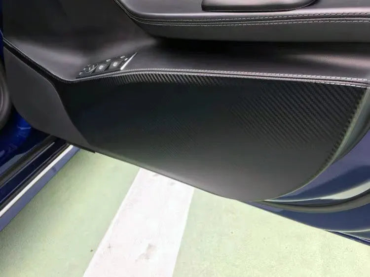 Tesla Model S door protective film package showing four transparent carbon fibre sheets for interior door panel protection